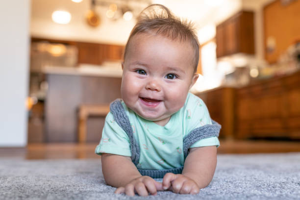 Baby laying on carpet floorings | The FloorWorks